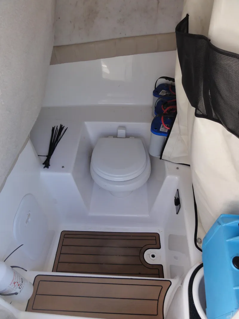 Slide: The Image of 2017 Sea Fox 249 Avenger boat interior with toilet and storage area. - 18