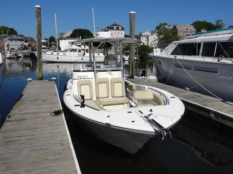 Slide: The Image of 2017 Sea Fox 249 Avenger boat docked at a marina on a sunny day. - 2