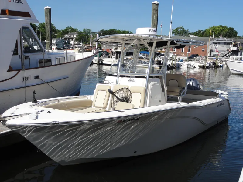 Slide: The Image of 2017 Sea Fox 249 Avenger boat docked in a marina, surrounded by other vessels. - 3