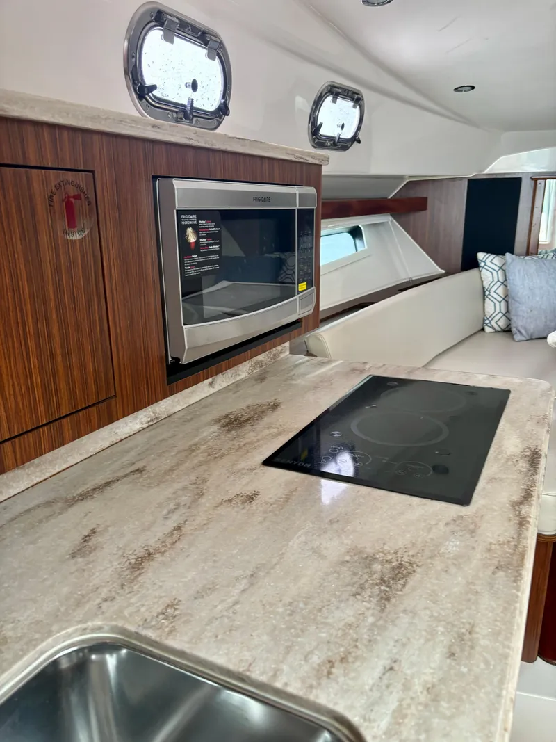 Slide: The Image of 2018 Pursuit OS 355 Offshore yacht interior with modern kitchen and appliances. - 14