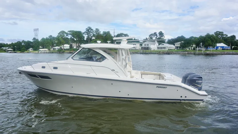 Slide: The Image of 2018 Pursuit OS 355 Offshore boat cruising on a calm river. - 4