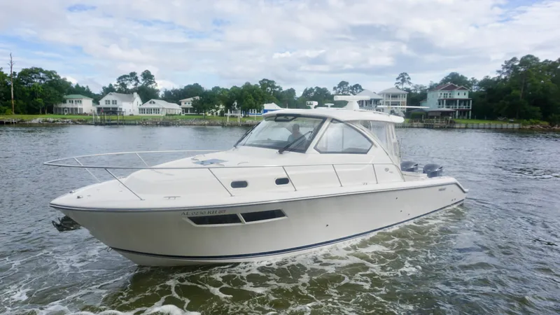 Slide: The Image of 2018 Pursuit OS 355 Offshore boat cruising on a scenic waterway. - 5