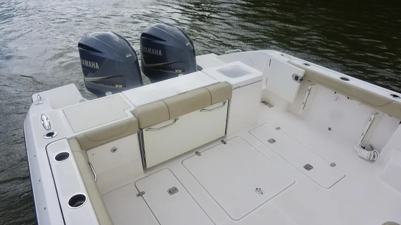 Slide: The Image of 2018 Pursuit OS 355 Offshore boat with twin Yamaha V8 engines on water. - 8