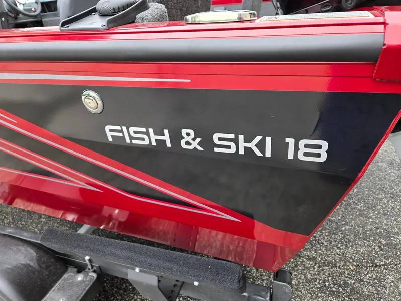 Slide: The Image of Red and black Lowe FS1800 Fish & Ski 18 boat, 2025 model, on a trailer. - 10