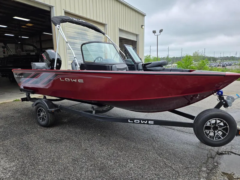 Slide: The Image of 2025 Lowe FS1800 boat in red on a trailer outside a warehouse. - 4