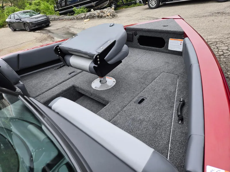 Slide: The Image of 2025 Lowe FS1800 boat interior with gray seating and carpeted deck. - 7