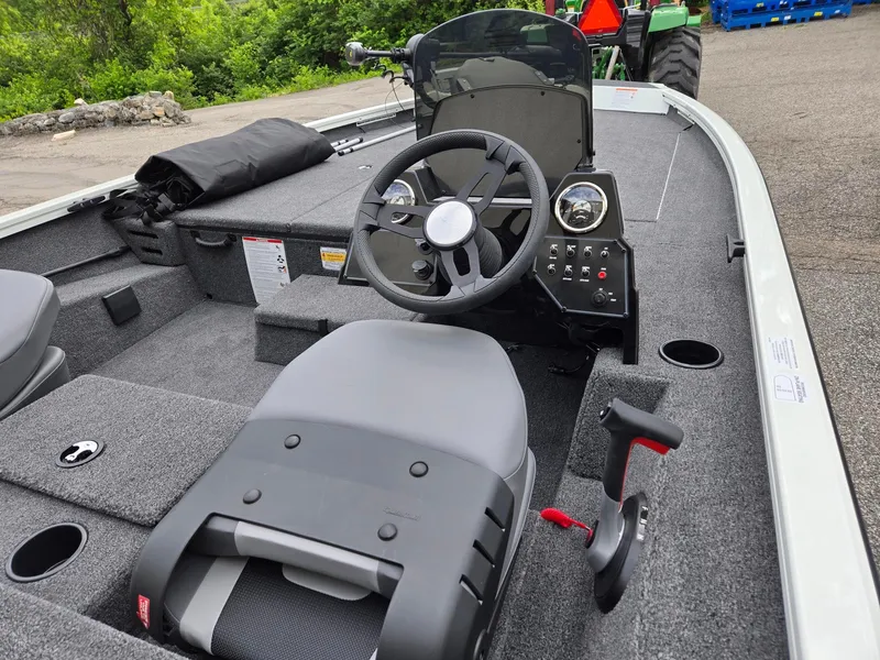 Slide: The Image of 2025 Lowe Stinger 195 Bass boat interior with steering wheel and control panel. - 4
