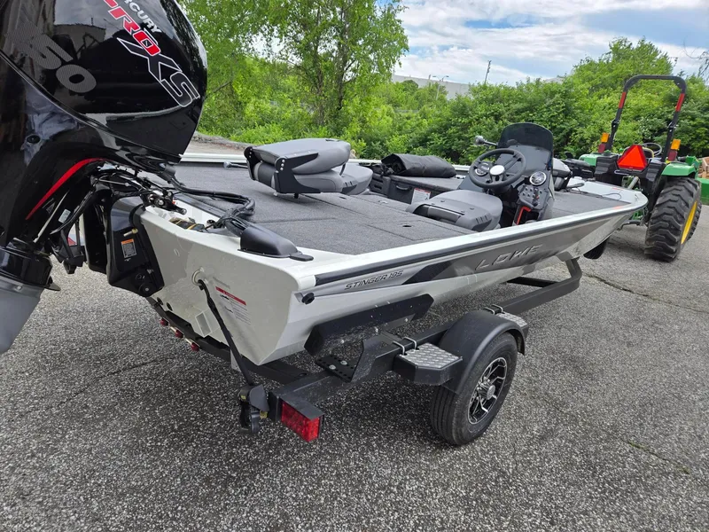 Slide: The Image of 2025 Lowe Stinger 195 Bass boat on trailer, featuring Mercury Pro XS engine. - 7
