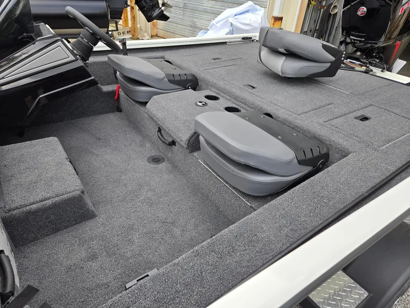 Slide: The Image of 2025 Lowe Stinger 195 Bass boat interior with folded seats and carpeted deck. - 9