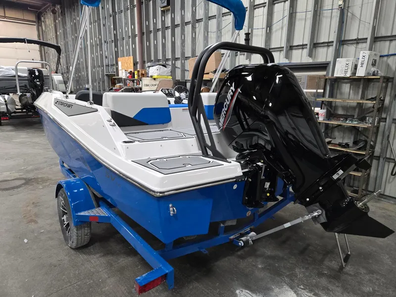 Slide: The Image of 2025 Starcraft SV16OB boat with Mercury outboard motor in a warehouse setting. - 3