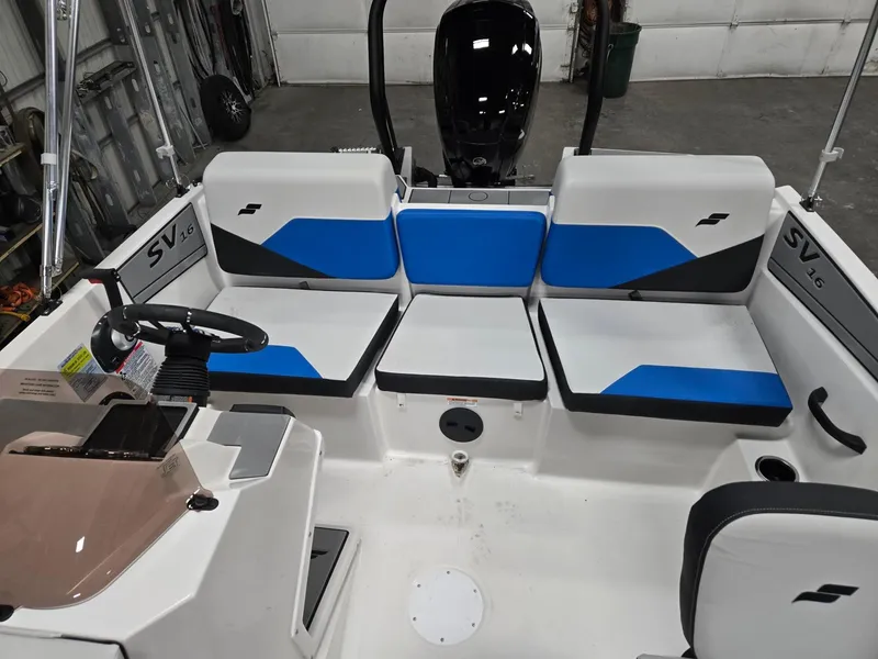 Slide: The Image of 2025 Starcraft SV16OB boat interior with blue and white seating, steering wheel, and control panel. - 6