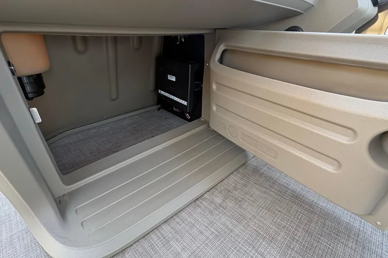 Slide: The Image of Storage compartment of 2025 Sun Tracker Sportfish 24 XP3 boat, featuring durable interior design. - 59