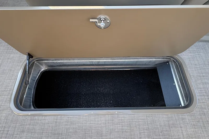 Slide: The Image of Storage compartment on 2025 Sun Tracker Sportfish 24 XP3 boat, open with latch. - 61