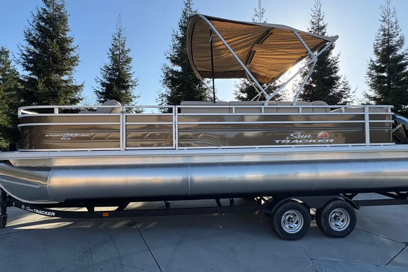 Slide: The Image of 2025 Sun Tracker Sportfish 24 XP3 pontoon boat with canopy, parked on trailer. - 65