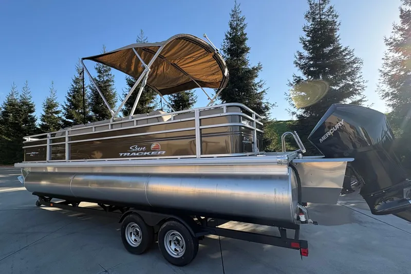 Slide: The Image of 2025 Sun Tracker Sportfish 24 XP3 pontoon boat with canopy and Mercury outboard motor. - 66