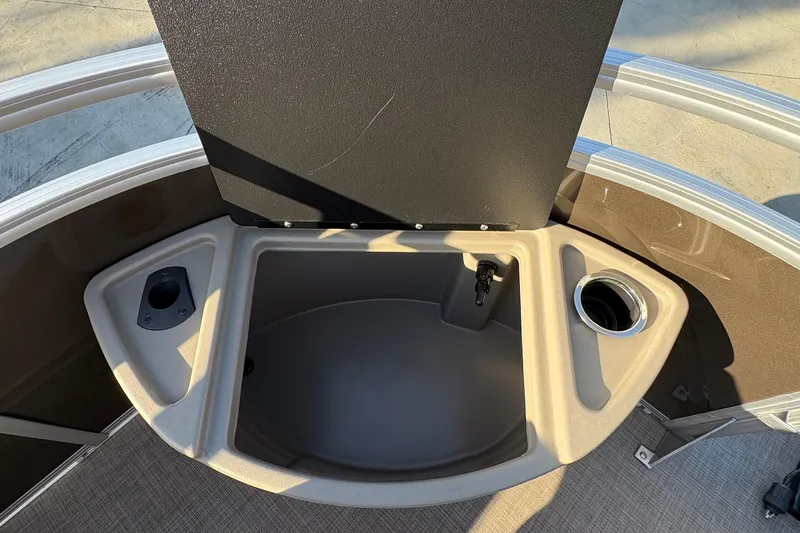 Slide: The Image of 2025 Sun Tracker Sportfish 24 XP3 boat interior with storage compartment and cup holder. - 72