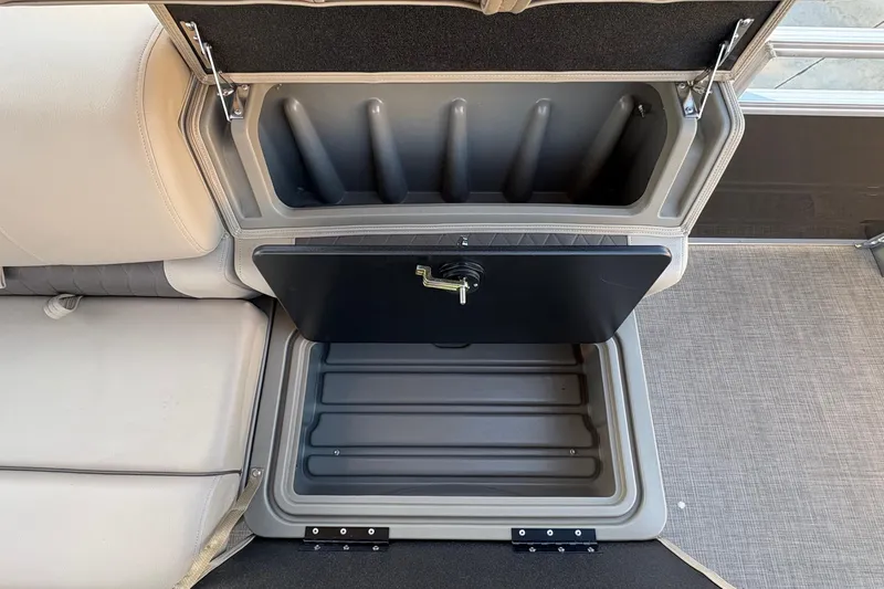 Slide: The Image of Storage compartment in 2025 Sun Tracker Sportfish 24 XP3 boat, featuring secure latch and ample space. - 75