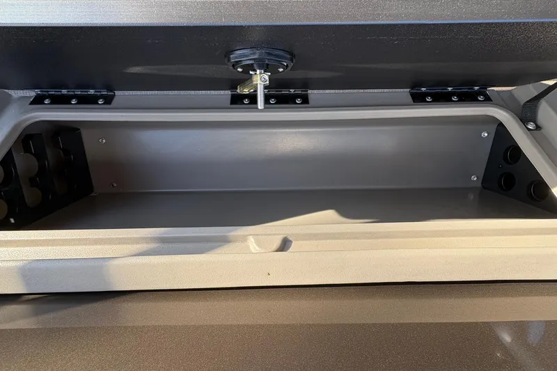 Slide: The Image of Storage compartment of 2025 Sun Tracker Sportfish 24 XP3 boat, open and empty. - 77