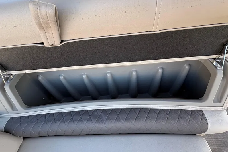 Slide: The Image of 2025 Sun Tracker Sportfish 24 XP3 boat seat storage compartment, featuring cushioned seating. - 81