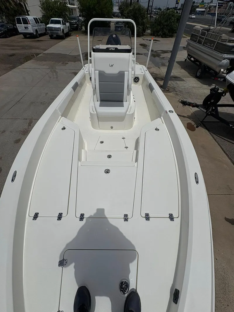 Slide: The Image of 2025 Mako 24 APEX boat, white deck, center console, outdoor display. - 11