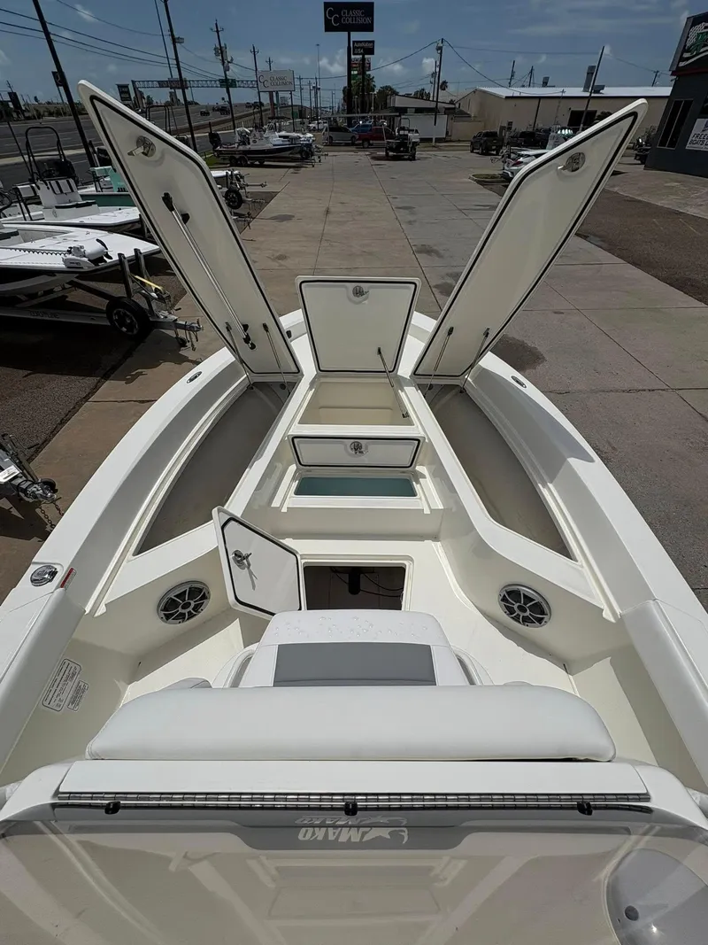 Slide: The Image of 2025 Mako 24 APEX boat interior with open storage compartments and seating. - 4