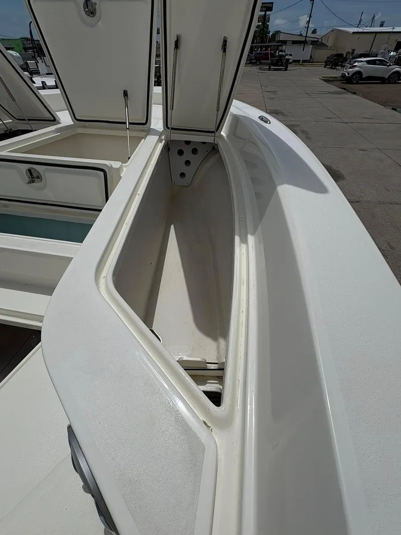 Slide: The Image of Open storage compartment on 2025 Mako 24 APEX boat, showcasing spacious interior design. - 8