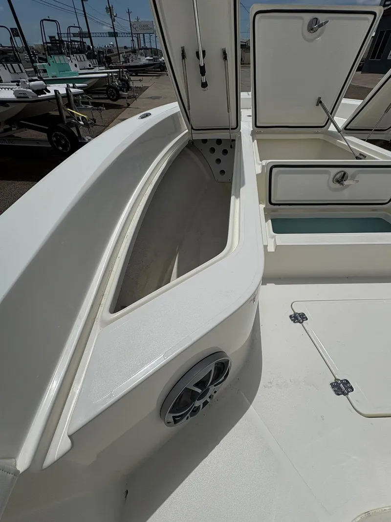 Slide: The Image of 2025 Mako 24 APEX boat interior with open storage compartments and speaker. - 9