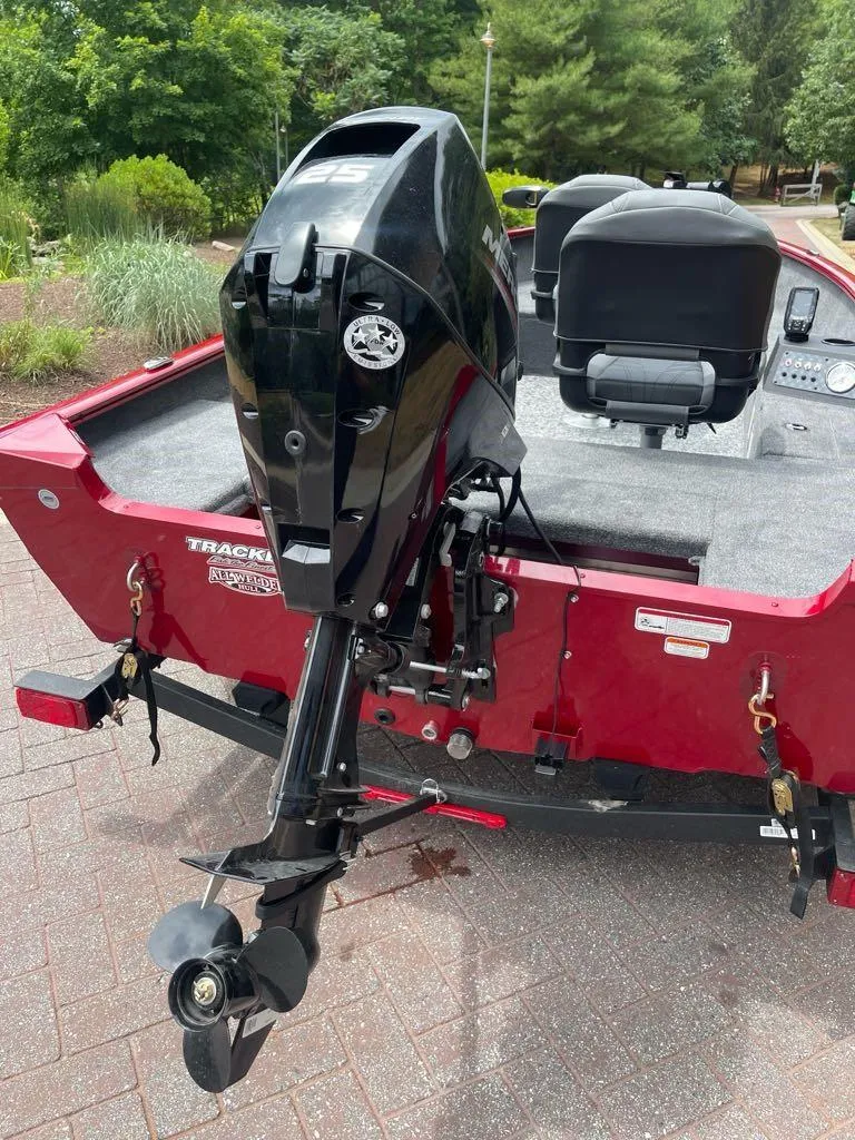 Slide: The Image of 2025 Tracker Super Guide V-16 T boat with Mercury engine, red exterior, and dual seats. - 5