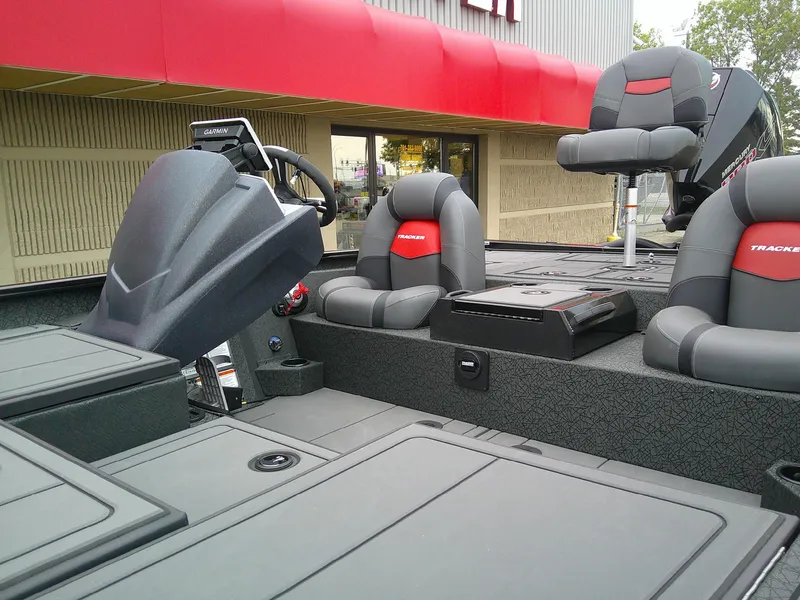 Slide: The Image of 2025 Tracker Savage 215 boat interior with modern seating and steering console. - 7