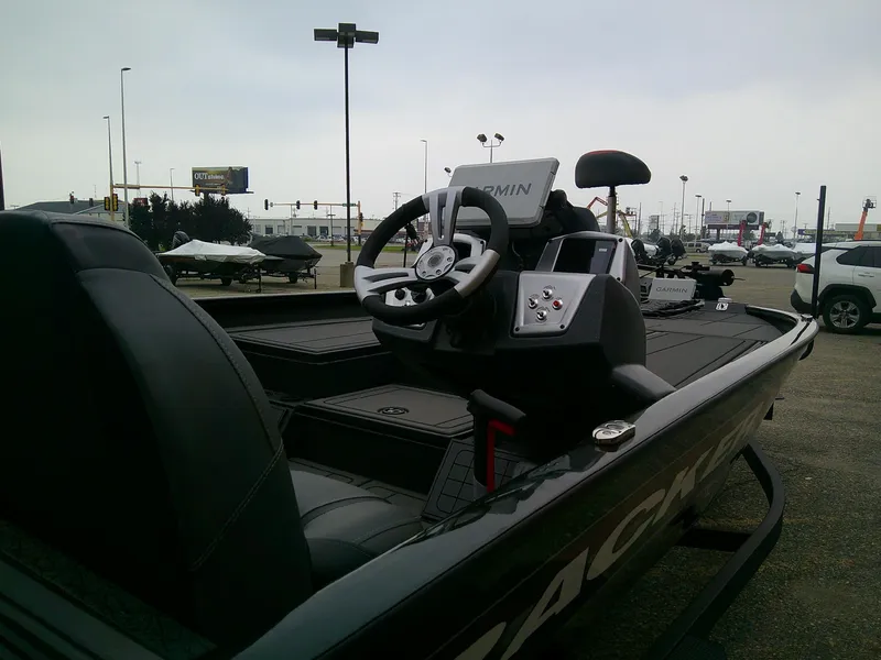 Slide: The Image of 2025 Tracker Savage 215 boat interior with steering wheel and Garmin navigation system. - 9