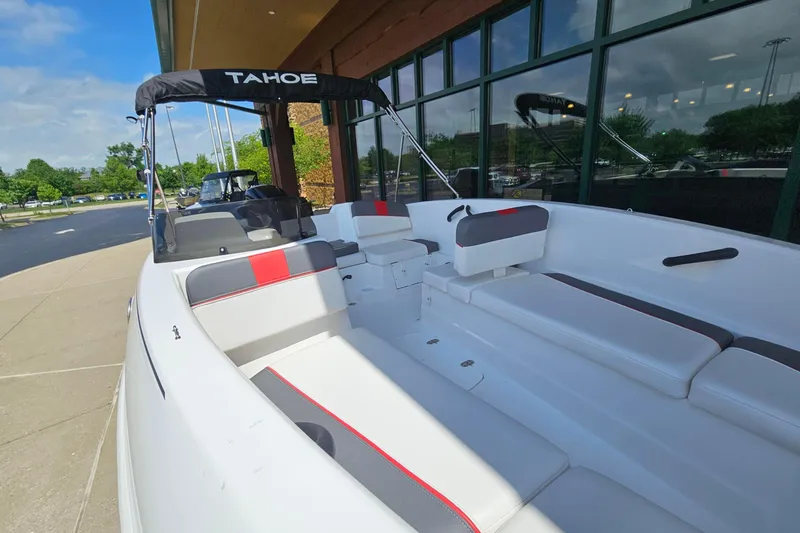 Slide: The Image of 2025 Tahoe T16 boat with sleek interior design, docked near a modern building. - 62