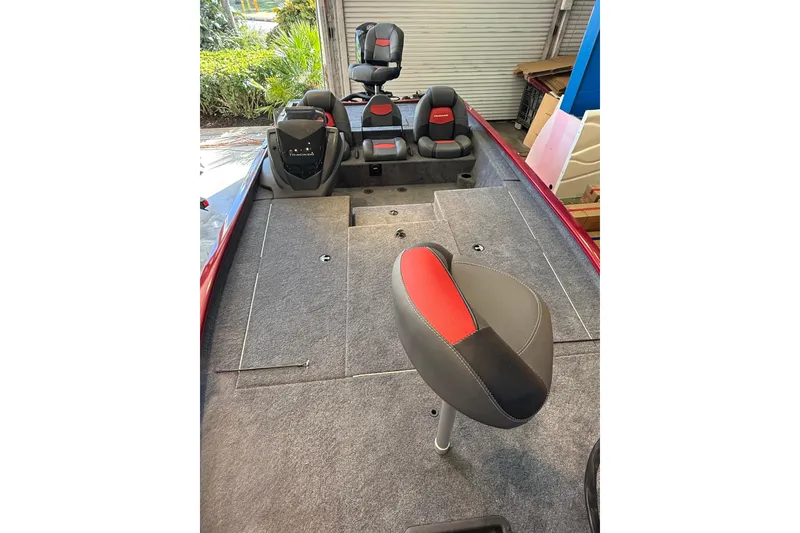 Slide: The Image of 2025 Tracker Savage 215 boat interior with red and gray seating, showcasing spacious design. - 6