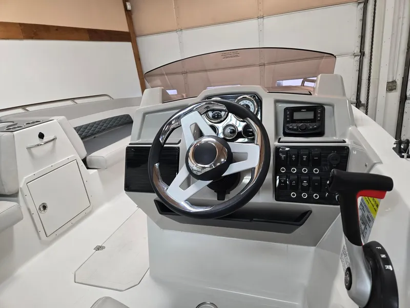 Slide: The Image of 2025 Starcraft SVX211OB boat dashboard with steering wheel and control panel. - 5