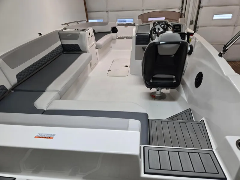 Slide: The Image of 2025 Starcraft SVX211OB boat interior with modern seating and steering console. - 6
