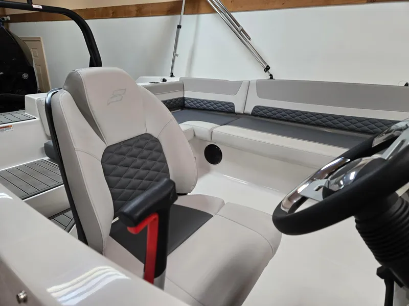 Slide: The Image of 2025 Starcraft SVX211OB boat interior with modern seating and steering wheel. - 7