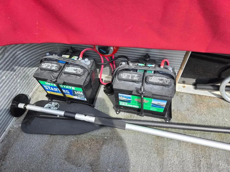 Slide: The Image of Two marine batteries and a paddle in a 1988 Sweetwater Executive Cruiser boat. - 10