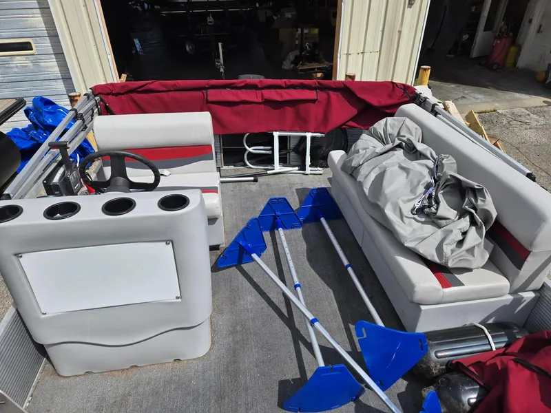 Slide: The Image of 1988 Sweetwater Executive Cruiser interior with steering console, seating, and blue paddles. - 6