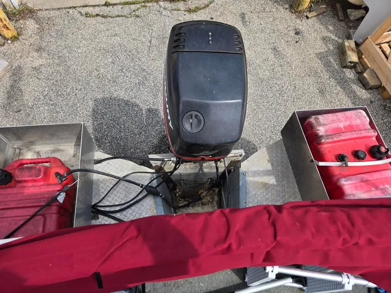 Slide: The Image of 1988 Sweetwater Executive Cruiser with outboard motor and red fuel tanks on deck. - 9