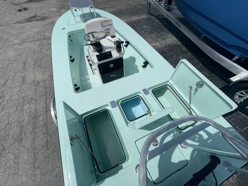 Slide: The Image of 2025 Maverick 17 HPX-S boat interior with open storage compartments and steering console. - 6