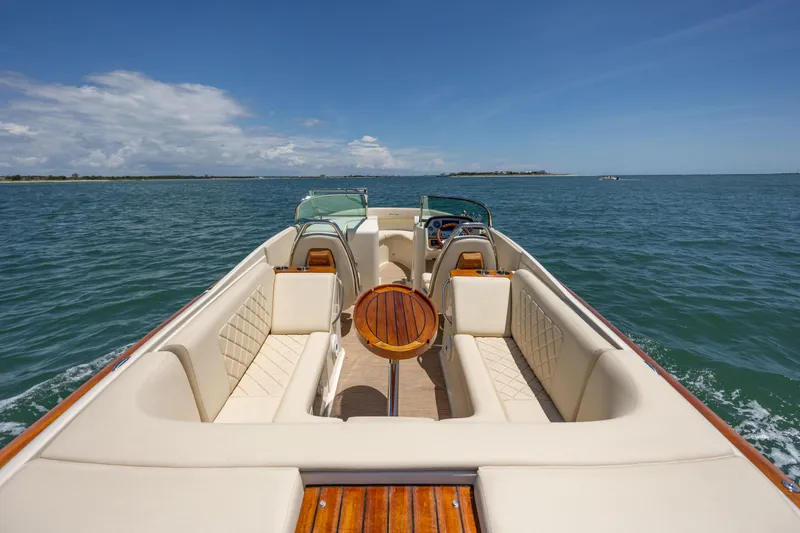 Slide: The Image of 2022 Chris-Craft Launch 27 boat on open water, featuring luxurious seating and elegant design. - 10