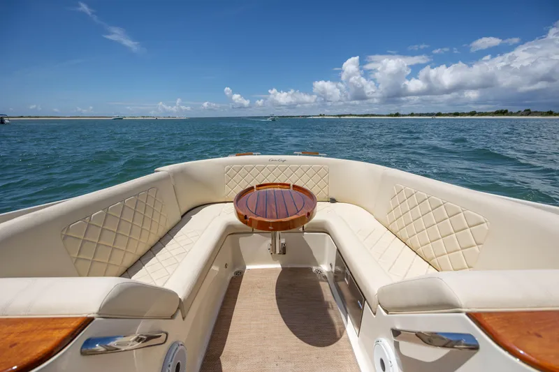 Slide: The Image of Luxurious 2022 Chris-Craft Launch 27 boat interior with elegant seating and wooden table. - 12