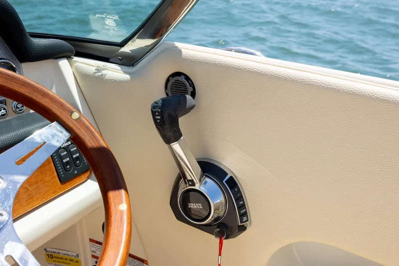 Slide: The Image of 2022 Chris-Craft Launch 27 boat interior with steering wheel and throttle control. - 18