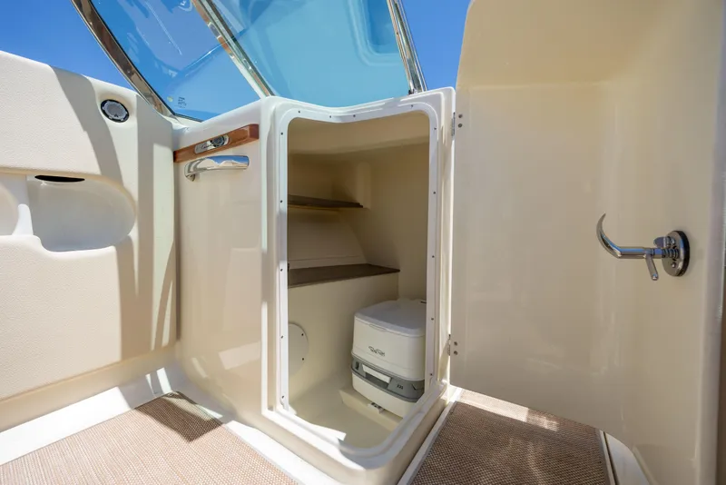 Slide: The Image of 2022 Chris-Craft Launch 27 interior with compact marine toilet and storage space. - 21
