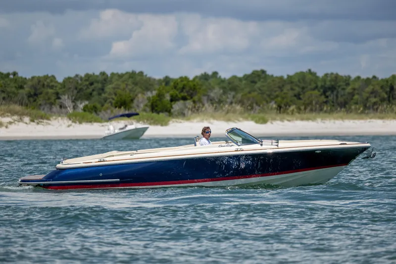 Slide: The Image of 2022 Chris-Craft Launch 27 boat cruising on a scenic waterway. - 5