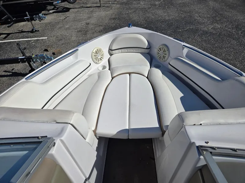 Slide: The Image of 2007 Four Winns 200 Horizon boat interior with white seating and speakers. - 11