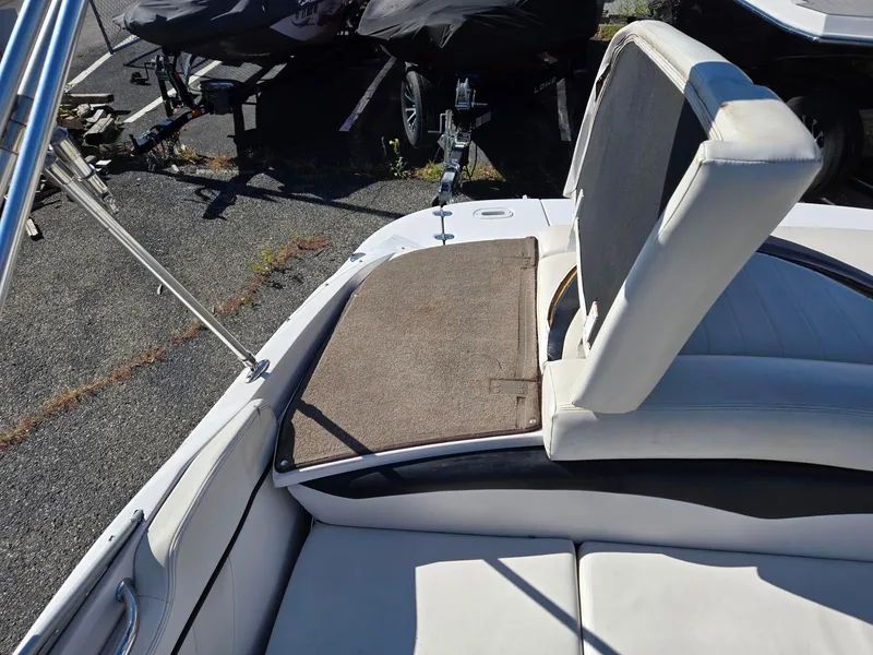 Slide: The Image of 2007 Four Winns 200 Horizon boat interior with white seating and brown carpet. - 12