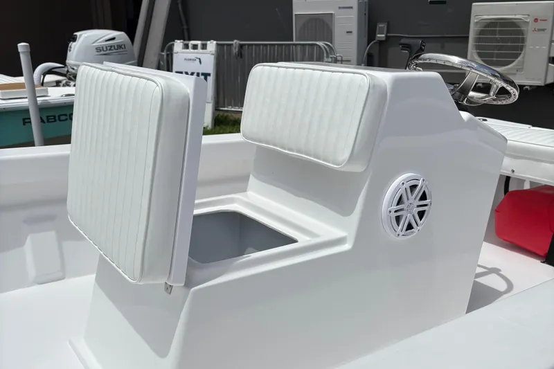 Slide: The Image of 2025 Rabco Buccaneer boat interior with white cushioned seating and steering wheel. - 5