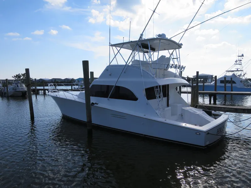 The Image of 1997 Post 50 Flybridge yacht docked at a marina. - 0