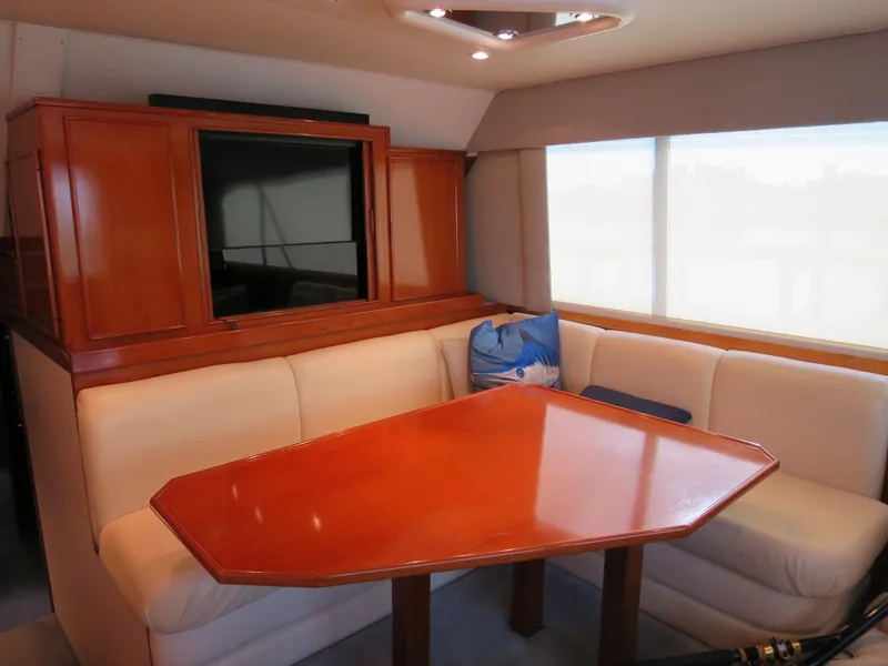 Slide: The Image of 1997 Post 50 Flybridge yacht interior with dining table and seating area. - 12