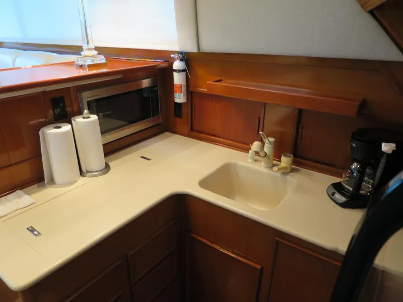 Slide: The Image of 1997 Post 50 Flybridge yacht kitchen with sink, microwave, and coffee maker. - 13